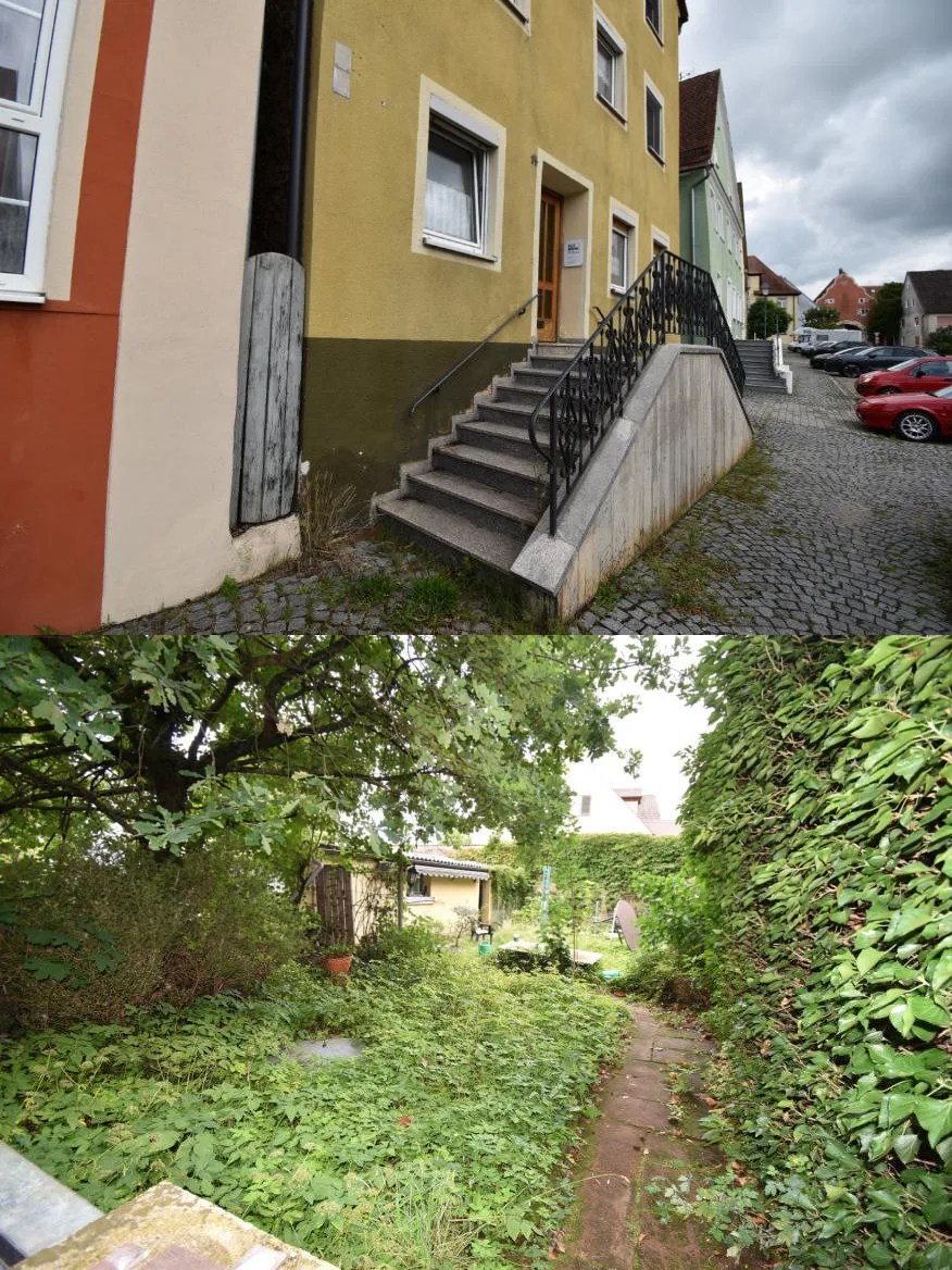 Frontansicht des gelben Wohnhauses mit Treppe und Eingang, klare Objektdarstellung