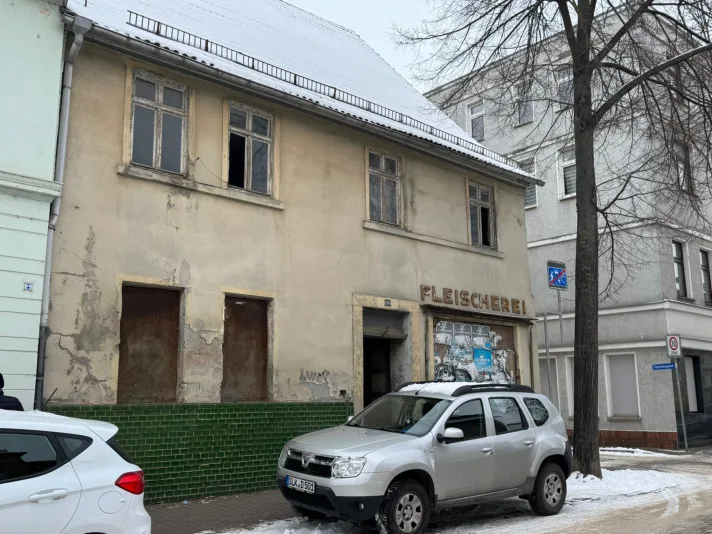 Main facade with commercial storefront at street level