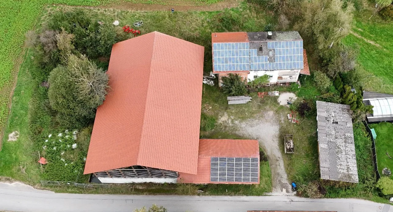 Aerial view of building complex with solar panel installations