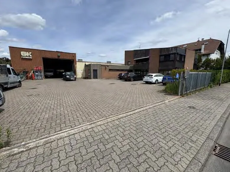 Front exterior view of industrial/commercial property complex with paved courtyard